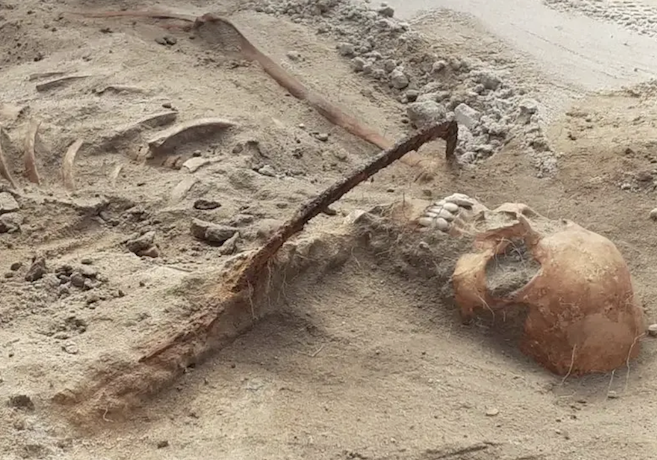 remains of woman with a sickle across her neck
